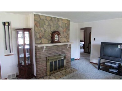 Living Room. Cozy Log Burning Stone Fireplace with