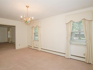 The dining room is large and open to formal living room and foyer beyond that.