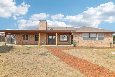 Back of house with a patio