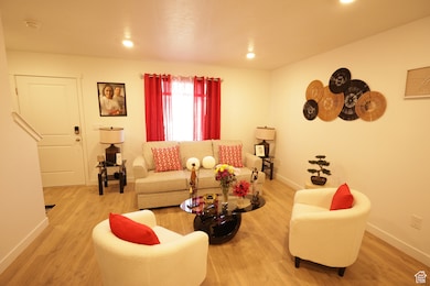 Living area with wood finished floors and recessed lighting