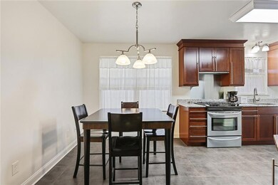 Eat in kitchen with gas stove and granite counters