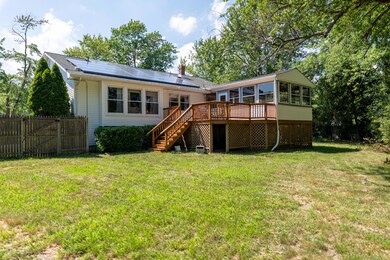 Back yard with deck and sunroom