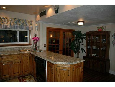 Kitchen. granite countertops with a bar area to si