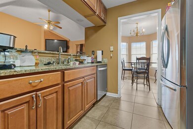 Kitchen with light tile patterned floors, stainles