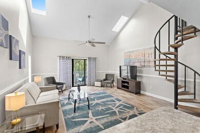 Living room featuring ceiling fan, hardwood / wood