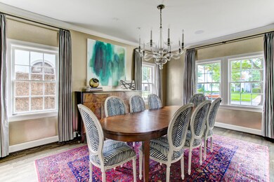 The refined and sophisticated formal dining boasts charming windows overlooking the manicured grounds. Notice the lovely Donghia “Looks like Etching” Gold bullion wallpaper and the elegant Circa chandelier.