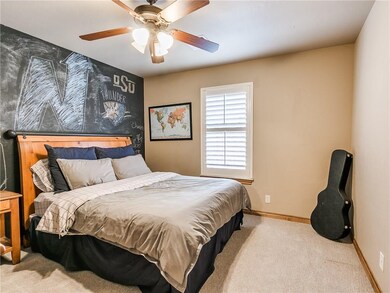 Guest bedroom with plantation shutters and chalkbo