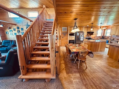 featuring wooden ceiling, stairs, light stone finish floors, and wooden walls