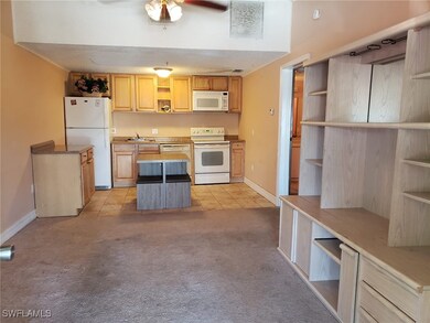 Kitchen featuring open shelves, white appliances,
