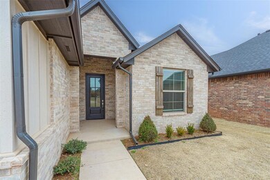 Entrance to property featuring brick siding