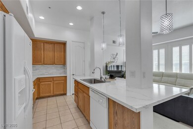 Kitchen featuring light tile patterned floors, a s