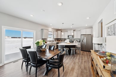 Enjoy plenty of seating at the kitchen island and dining area adjacent to the kitchen. Perfect for entertaining or having a family meal together. (Photo of decorated model, actual home's finishes may vary slightly)