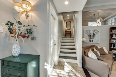 Hall featuring a chandelier, ornamental molding, a