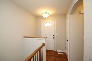 Gleaming Hardwood in Foyer Entry