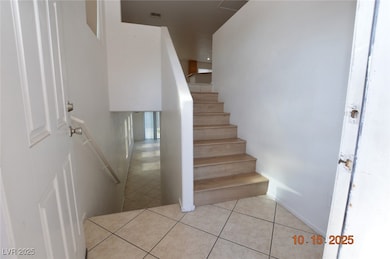 Stairway featuring tile patterned floors