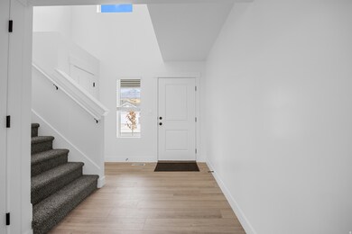 Entryway featuring light wood-type flooring and stairway