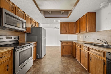 Kitchen with a textured ceiling, stainless steel 