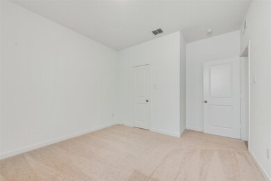 Unfurnished bedroom featuring light colored carpet