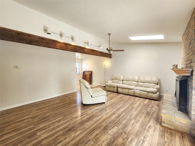 Unfurnished living room featuring baseboards, a f