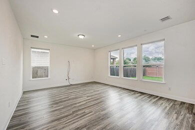 Spare room featuring wood finished floors and rec