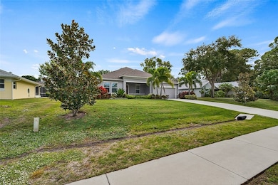 View of front of house with concrete driveway, a front lawn, a garage, and stucco siding