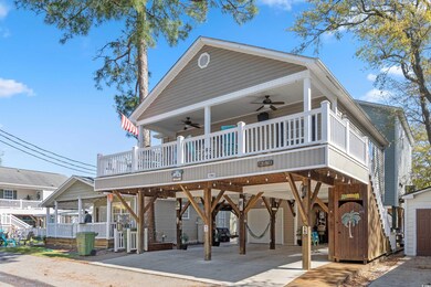 Coastal inspired home featuring a carport, ceiling