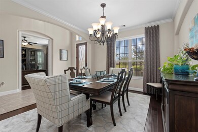 In the formal dining room you will see crown molding and custom window coverings.