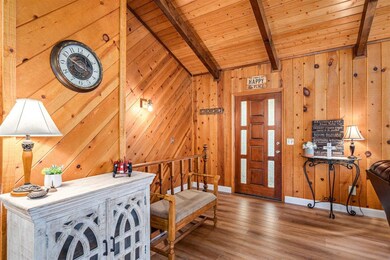 Interior space featuring wood walls, wooden ceiling, hardwood / wood-style floors, and lofted ceiling with beams