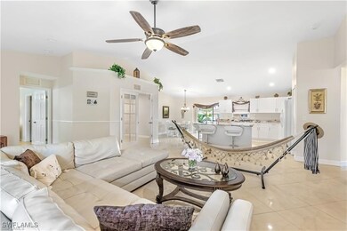 Living area with ceiling fan, light tile patterned