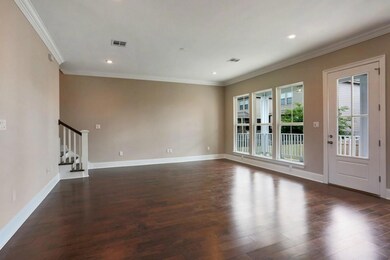 Livingroom overlooks bricked porch and rear yard