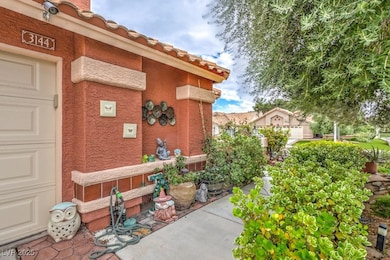 Doorway to property featuring stucco siding and a tiled roof