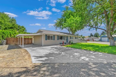 Ranch-style house with concrete driveway and a carport