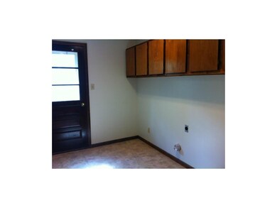 Laundry room, just off kitchen, includes door to d