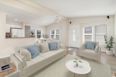 Living room featuring lofted ceiling with beams, l