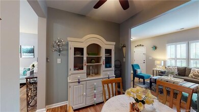 Dining area with overhead lighting and ceiling fan