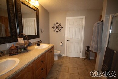 Master bath has double sinks, shower, and walk-in 