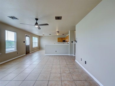 Unfurnished living room featuring baseboards, cei