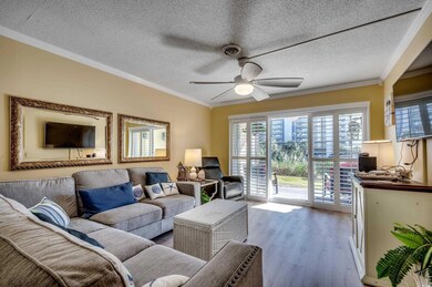 Living room with ceiling fan, light wood-type floo