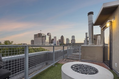 View of patio / terrace with a fire pit and a skyline view