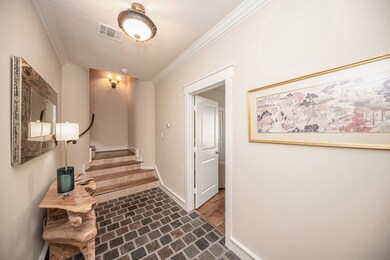 This photo showcases a welcoming foyer with brick