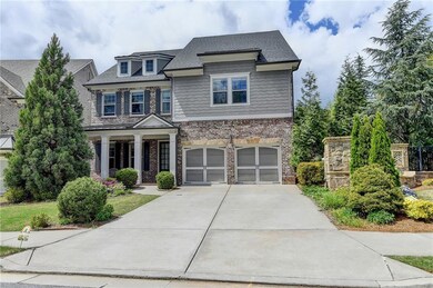 Craftsman-style home featuring covered porch, driv