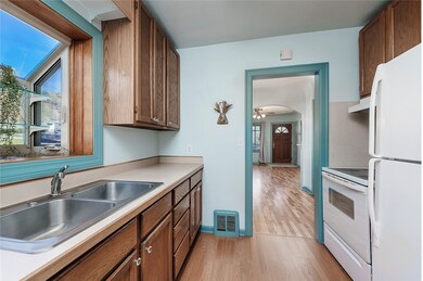 Galley style kitchen with garden window over sink,