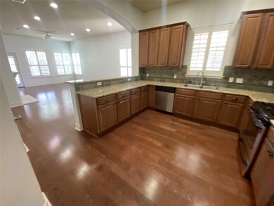 Kitchen with stainless steel dishwasher, a sink, 
