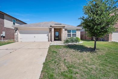 View of front of home with a garage and a front yard