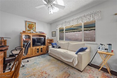 Living room with a textured ceiling, wood finished