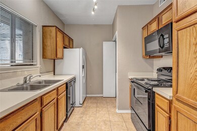 Kitchen featuring electric range oven, a textured 