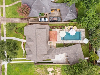 Aerial view of house, garage, pool and green space