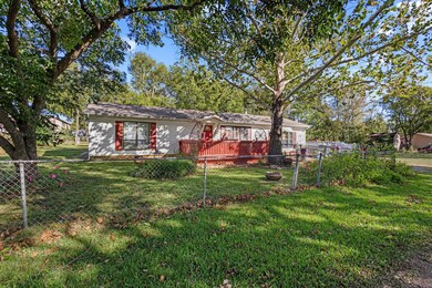 Front of property with  fenced backyard and a wooden deck