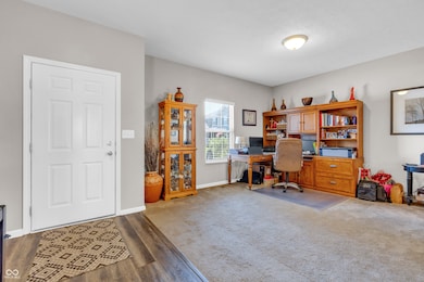 office area with baseboards and wood finished floors