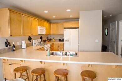 Nice sized kitchen with breakfast bar; faces dinin